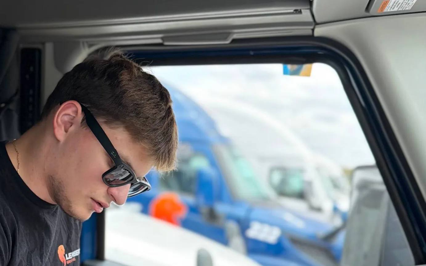 Driver filing the load paperwork in the cab