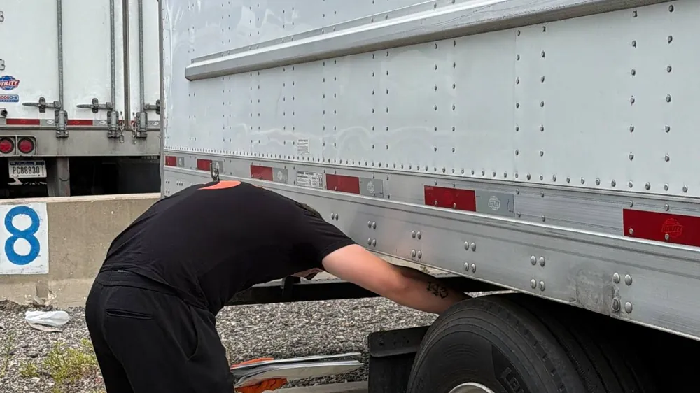 Driver at the doors of a 53-foot dry van trailer
